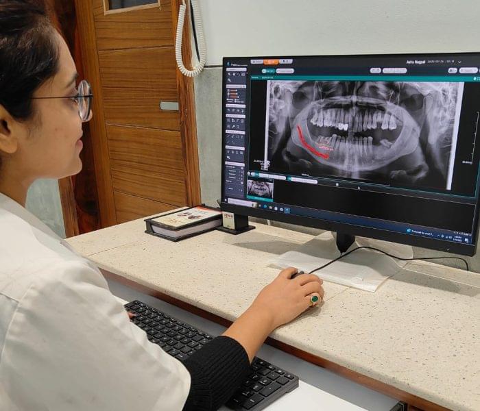 Dr. Shalini Singh examining the Dental X-ray in the system Dr. Shalini Singh examining the Dental X-ray in the system